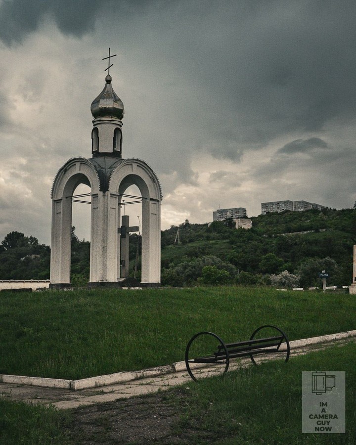 My recent journey to Moldova, Transnistria, Ukraine and Romania.
Back in Rezina after Transnistria, late afternoon. The light had turned that pre-storm quality where everything goes green-grey. This chapel sits at the edge of a park, bench in front, nobody around.
#Moldova #Rezina #OrthodoxChurch