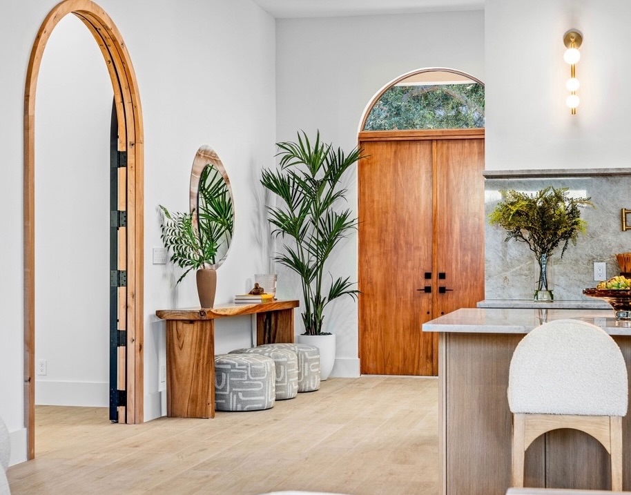 There’s something timeless about a beautifully crafted arch. In this space, soft architectural curves to add character, warmth, and a sense of flow throughout the space. Paired with natural wood tones, organic textures, and a warm neutral palette, the arches create an inviting first impression while adding a custom, elevated feel.
From the arched doorway to the statement entry to the counter stools, these details prove that great design is often found in the architecture itself.
Do you prefer clean lines or graceful curves? We’re firmly on Team Arches. 🤍
#REHInteriors #LuxuryInteriors #PalmBeachDesign #SouthFloridaDesign #LuxuryHome