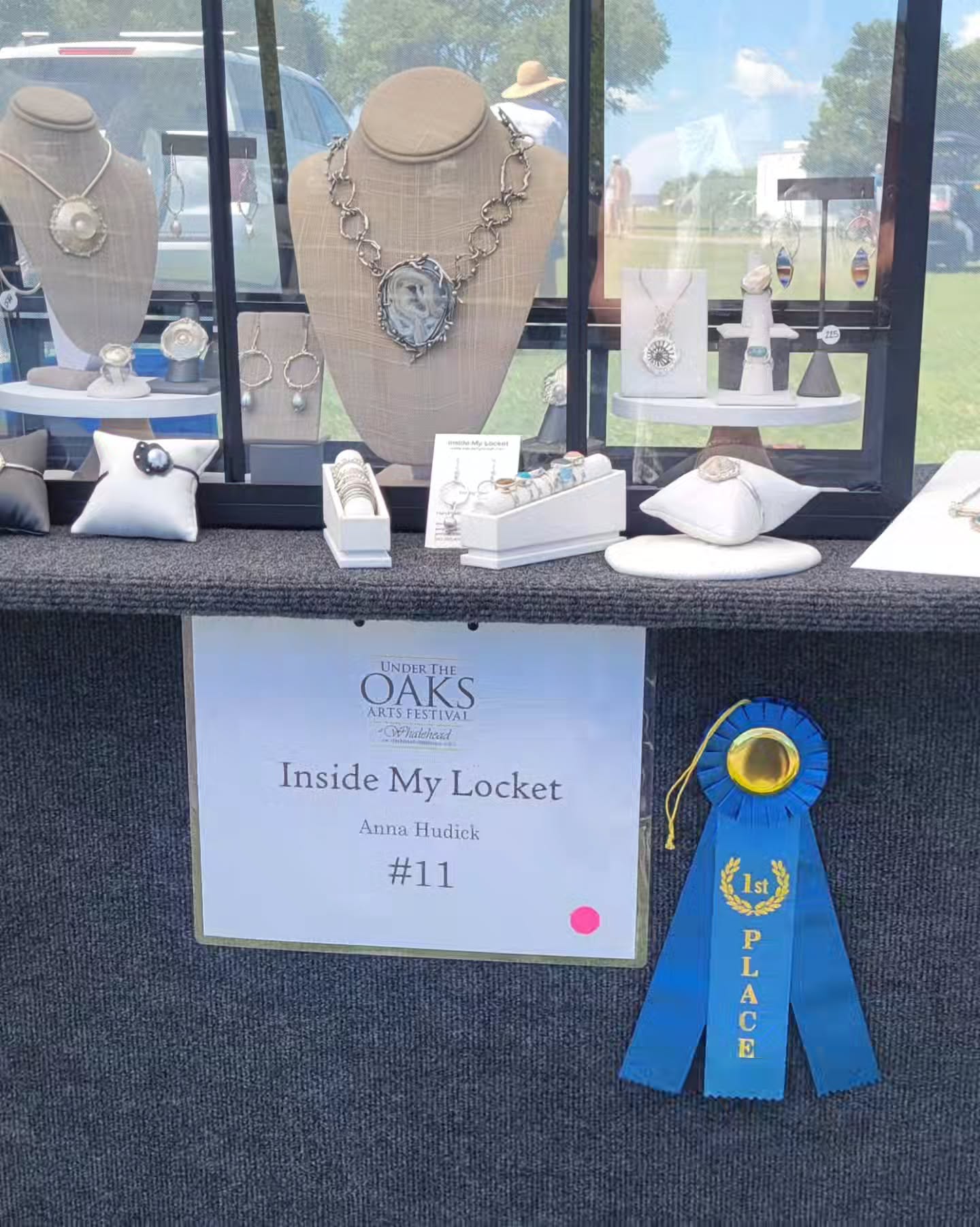 I'm honored (and still smiling) to have been awarded First Place in Jewelry at the Under the Oaks Arts Festival in Corolla, NC.
One of the judges stopped by my booth and asked which piece was my favorite. I shared the sapphire ring that represents the direction I hope to continue exploring, organic silver textures paired with flush-set gemstones. To have that work recognized is incredibly encouraging.
Thank you to everyone who stopped by Booth #11, shared conversations about my work, or took a piece of Inside My Locket home with them. Moments like these make all those hours at the bench worthwhile. 💙