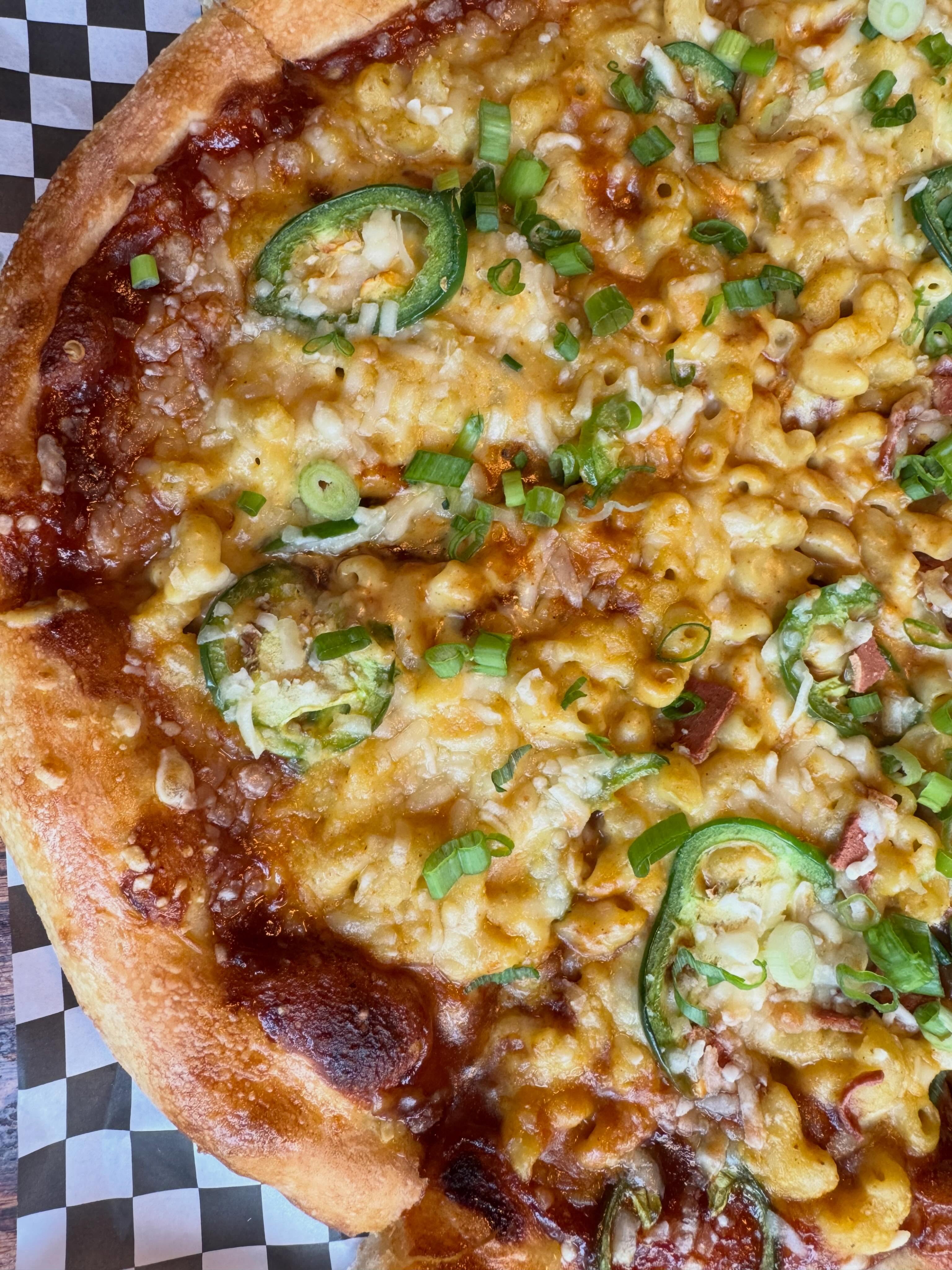 🤠 Buckle up… our July Features have officially arrived!
In true (cruelty-free) Calgary Stampede fashion, we’re serving up a little midway magic to keep you fueled all month long. 🎡🍕
🍕 Feature Pizza:
BBQ Mac & Cheeze with jalapeños, bakon, mozzarella, green onions, and caramelized onions.
🍰 Feature Cheezecake:
Butterscotch S’mores 🤤 with a Dad’s Cookie crust, roasted marshmallow, and a rich butterscotch chip cashew filling, finished with a buttery caramel drizzle.
🥤🫐 Kombucha of the Month:
@happybellykombucha Saskatoon Farm
Available all July while quantities last- come taste summer before it’s gone! 🌞