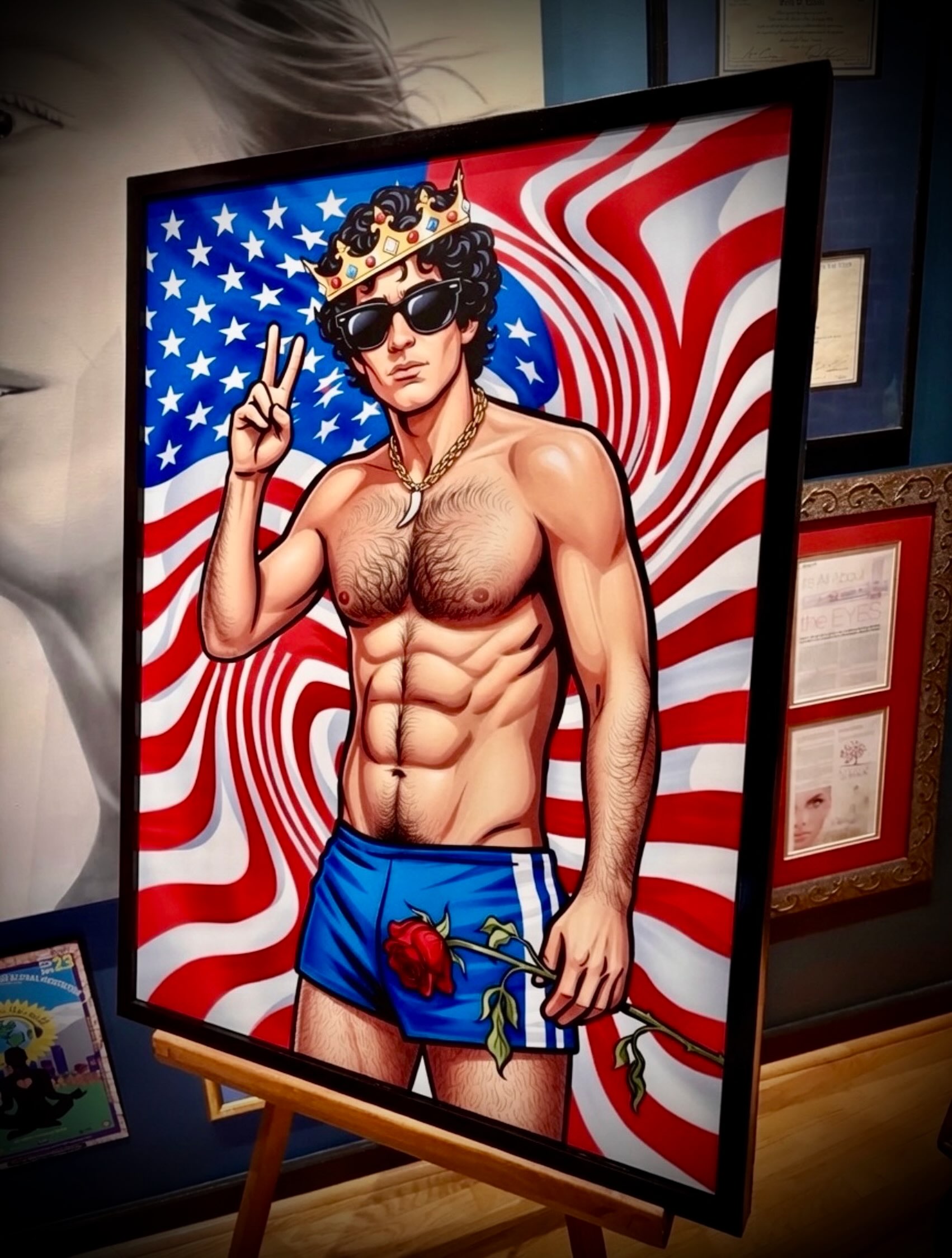 THE PRINCE
On the 250th birthday of a nation continuously struggling to fulfill its promise, I find myself thinking about the beautiful boy in my piece THE PRINCE — John F. Kennedy Jr, from my 27-piece series GLARE: Shades Of Fame.
Not as an icon.
Not as a celebrity.
But as a symbol…and, as a question.
What does America do to the people onto whom it projects its greatest hopes?
The warped American flag isn’t just a backdrop. It represents a country whose ideals have too often been distorted by fear, power, violence, and division—a nation still wrestling with the distance between its promise and its reality.
The crown was never his.
America placed it there, desperate for another Camelot. We crowned a beautiful boy with impossible expectations before he ever had the chance to simply be a man.
And what about the peace sign?
Is it naïve? Is it defiant? Or is it a reminder of what we’ve forgotten?
At 250 years old, why does peace still feel like the most revolutionary thing we could ask of ourselves?
The wilted rose is Camelot. It is innocence. It is the dream that America could become more just, more compassionate, and more equal—a dream interrupted by tragedy, yet one we still refuse to let die.
This work isn’t about nostalgia.
It’s about what happened to a family—and a young man—who came to represent the possibility that America could become better.
Whether history fulfilled or shattered that promise is for each of us to decide.
This piece asks whether we’ve honored that vision… or abandoned it.
It also reminds me that no crown has ever made a nation great.
Only its people can do that.
#TheRoccoPink #SymbolicPopArtExpressionism #America250 #ThePrinceJohnFKennedyJr #ContemporaryArt