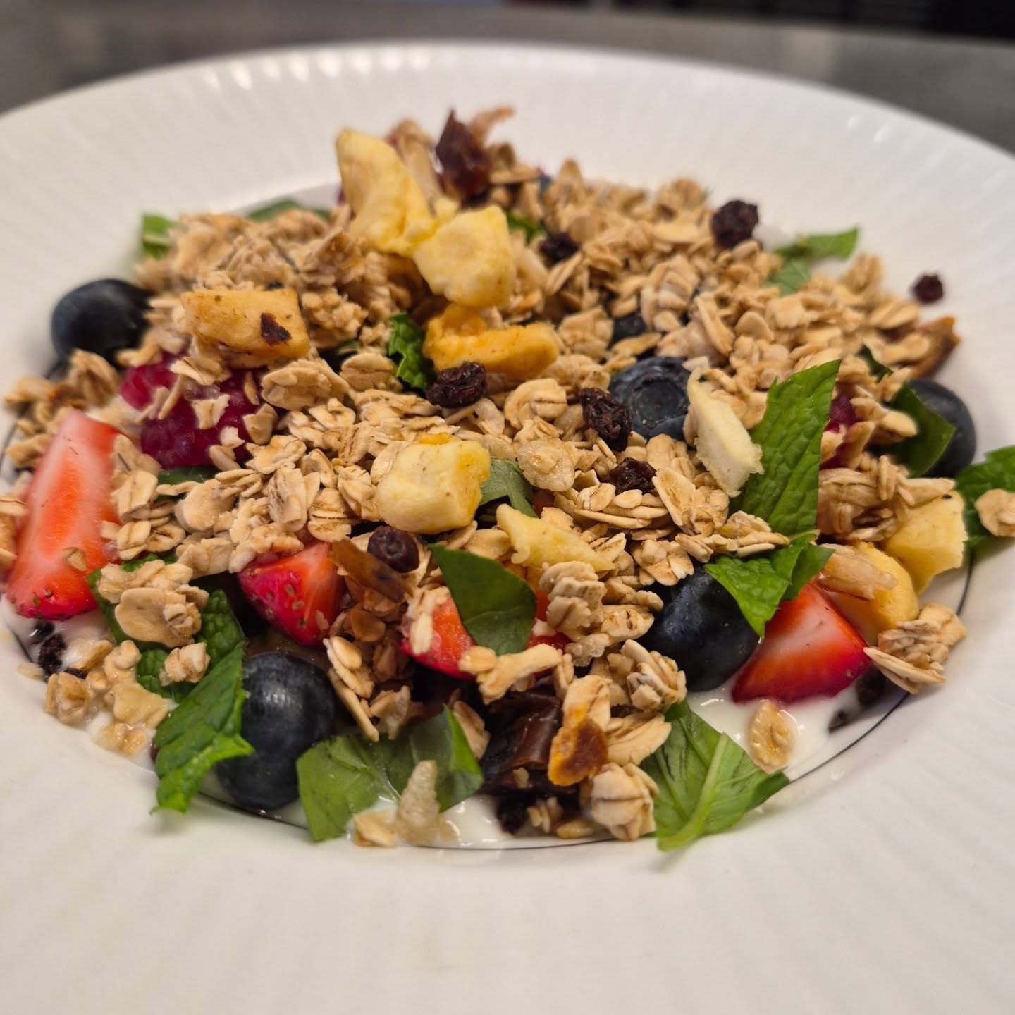 You've been patient and today is the day! Our Cafe fruit bowl is back! @strausmilk yogurt, dried fruit, farmers market berries, @bobsredmill granola and mint and basil from our garden!