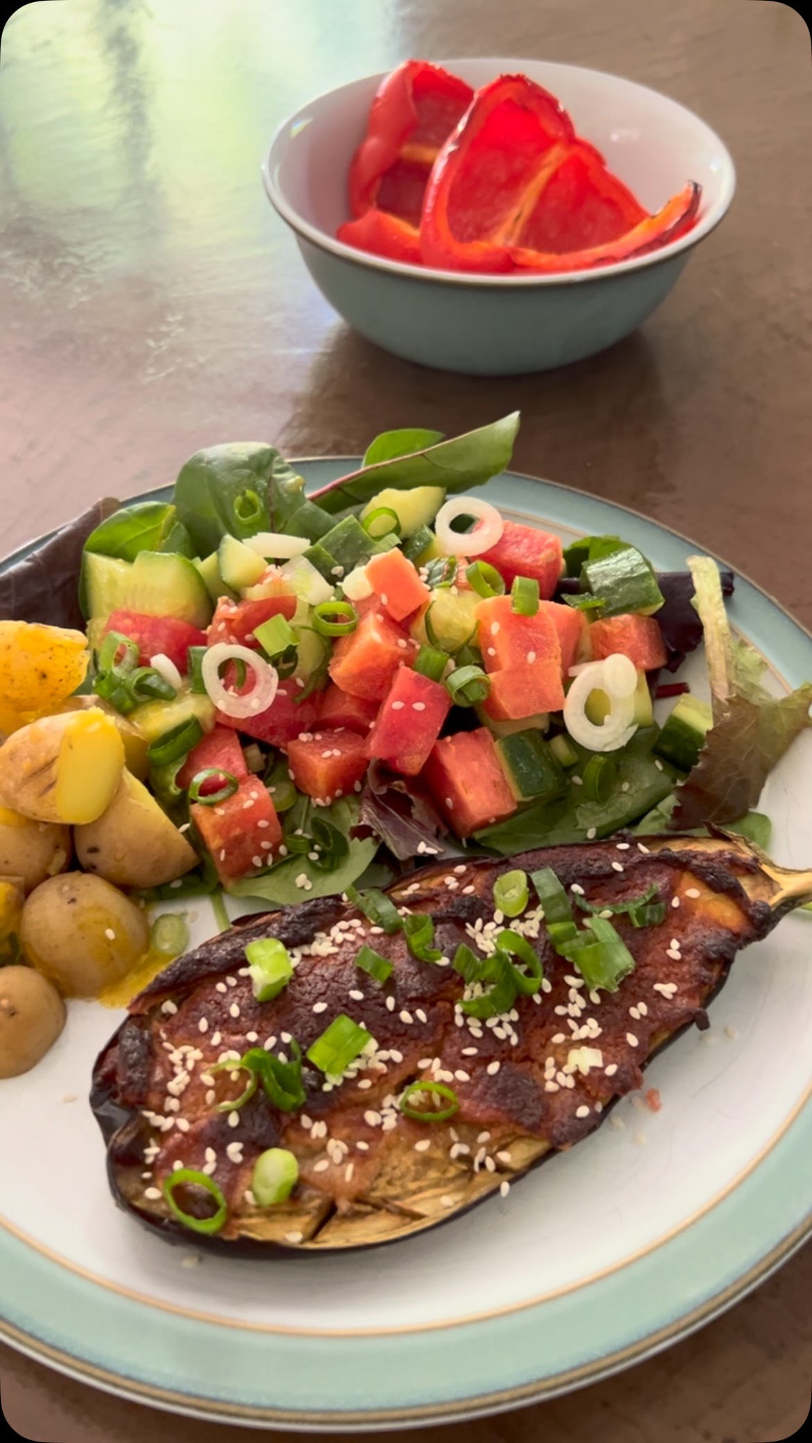 Gorgeous miso & tahini glazed aubergine for lunch today with a cucumber & watermelon salad and a few baby potatoes. So simple but so satisfying โบ๏ธ
I cut the aubergine lengthways and scored each half with a criss cross pattern. Drizzled with a little oil and baked for 20 minutes at 200 degrees.
I also roasted a couple of halved peppers at the same time - great to add things for the next meal when the oven is hot anyway โบ๏ธ๐
Whilst the aubergine was in the oven I mixed a tablespoon of miso paste and a tablespoon of tahini together with probably a teaspoon of maple syrup.
After 20 minutes I removed the aubergines and the peppers - the peppers were set aside as I donโt need them until tomorrow. ๐ค๐
I spooned the miso mix on each aubergine half. Back in the dish and the oven for another 15 minutes until cooked through and golden. Serve immediately.
If you havenโt tried aubergine this way I can highly recommend it. ๐
#aubergines #eggplants #miso #tastylunch #summervibesโ๏ธ