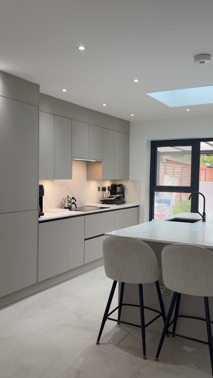Check out this recently completed modern kitchen project. We focused on maximizing natural light and creating an effortless flow for everyday living and entertaining.
Design Highlights:
Central Island: Features a sleek waterfall-style countertop, integrated undermount sink with modern black hardware, and built-in electrical outlets for seamless functionality.
Seating & Atmosphere: Paired with soft, off-white upholstered barstools that complement the neutral matte cabinetry.
Light-Filled Space: A skylight directly above the island combined with full-width black framed bi-fold doors connects the interior effortlessly to the garden.
What’s your favorite detail—the subtle light accents or the seamless indoor-outdoor transition? Let us know below! 👇
Hashtags
#KitchenDesign #ModernKitchen #KitchenInspiration #InteriorDesign