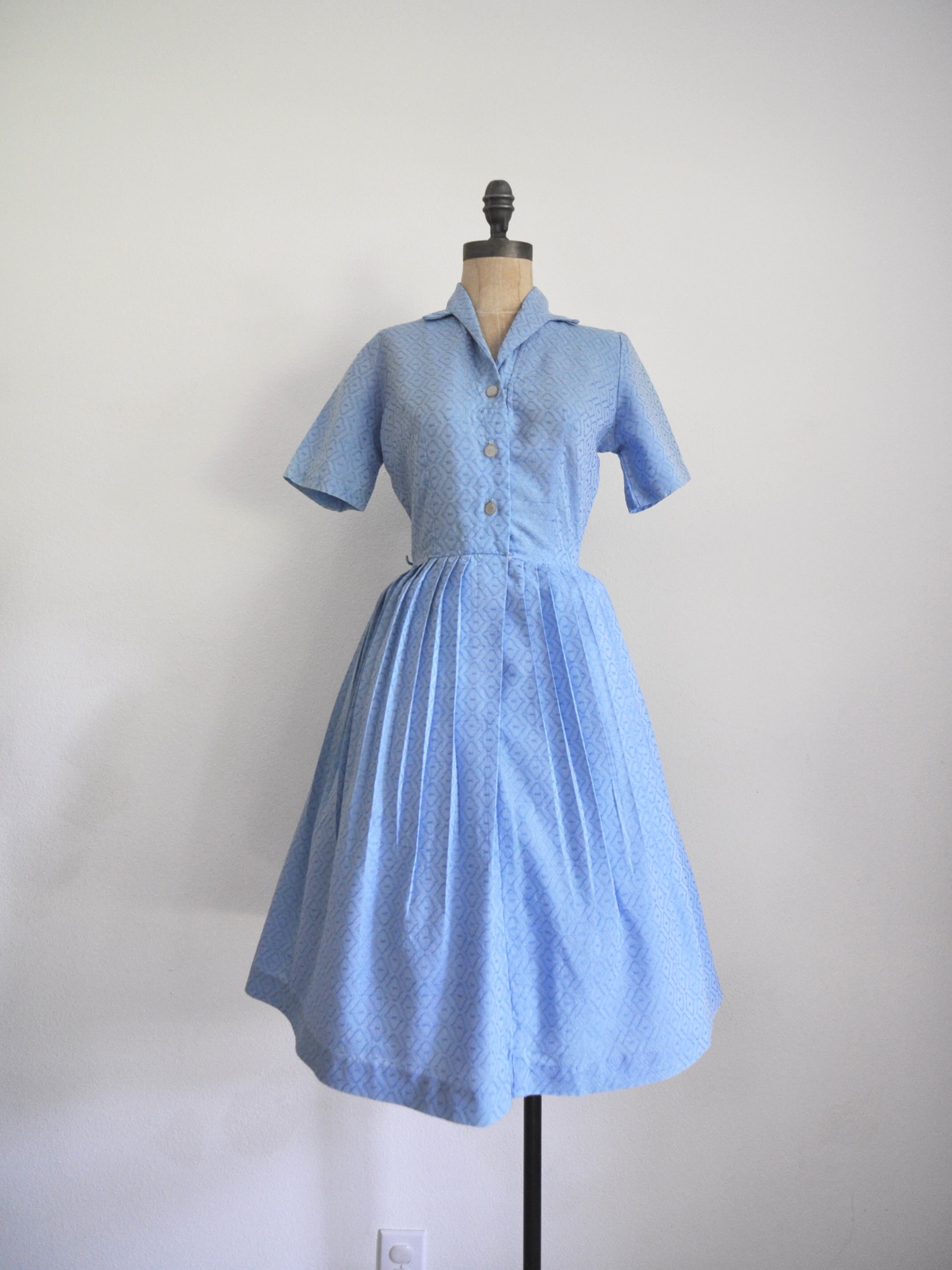🩵SOLD🩵 Blue 1950’s shirtwaist dress. Functional buttons, pleated skirt. Bust: 35” Waist: 26” Length: 40” Shoulder to waist: 15”