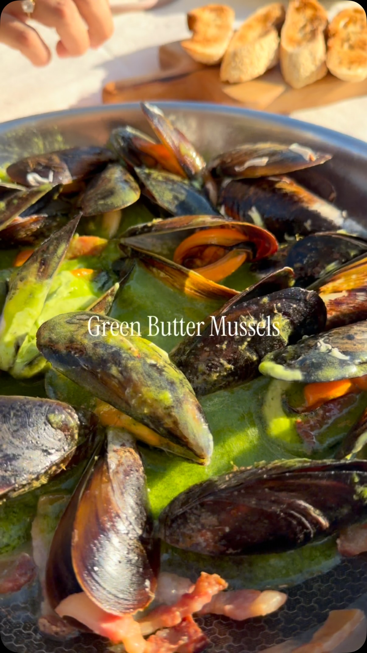 Green Butter Mussels
Recipe:
Serves 2
Ingredients
* 1 kg fresh mussels
* 200 g guanciale, diced
* 150 g butter
* 1 onion
* 1 garlic clove
* 1 large handful fresh coriander
* 2 tbsp olive oil
* Zest and juice of 1 lemon
* 100 ml dry white wine
* Salt, to taste
* Black pepper, to taste
* Microgreens or fresh herbs, to garnish
* Crusty bread, for toasting
Method
1. Prepare the green butter: add the onion, garlic, coriander, olive oil, lemon zest and lemon juice to a blender. Blend until smooth. Add the butter and blend again until completely emulsified and vibrant green. Set aside.
2. Clean the mussels thoroughly, removing the beards and scrubbing the shells. Discard any broken or damaged mussels.
3. Add the diced guanciale to a large pan over medium heat. Cook until golden and crispy, allowing the fat to render.
4. Add the raw mussels to the pan with the guanciale.
5. Deglaze with the white wine, cover and cook until the mussels open.
6. Add the green butter and gently toss to combine with the mussel juices, white wine and guanciale.
7. Season with black pepper and adjust the seasoning if necessary.
8. Serve immediately with toasted crusty bread.