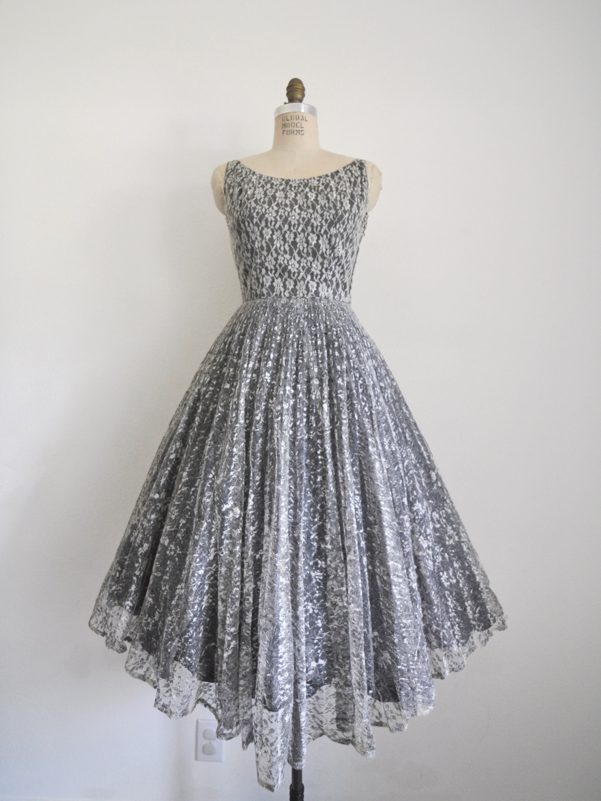 Link in bio to shop! Beautiful 1950’s Emma Domb party dress. Fully lined, side zipper, fitted waist. Some of the rhinestones are dull consistent with age. Teeny part of the lace is worn but otherwise great vintage condition. See photos. Bust: 35” Waist: 26” Length: 46” Shoulder to waist: 15”