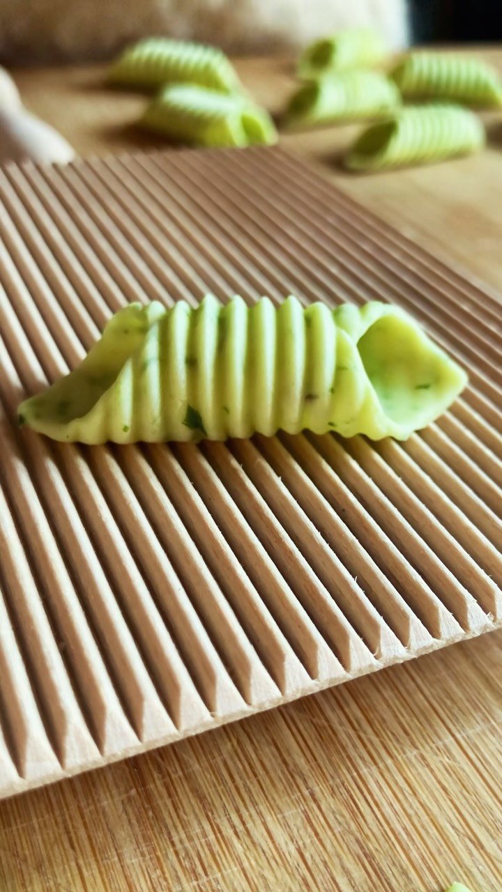 If you’ve been wanting to start making pasta but you’re just not quite sure how to begin, let this be your sign to make a semolina dough (my recipe is at the end of this caption for anyone who needs it) and try your hand at garganelli-rolling.
The gnocchi board it’s rolled on is honestly one of the most versatile and affordable tools you can own, and you can make anything from garganelli to cavatelli to rigatoni, just by changing how you roll the dough across it. It’s probably the first tool for anyone’s growing homemade pasta studio!
My semolina dough:
· 300g semolina flour
· 150g lukewarm water
Make a well in the semolina, add the water to the center, and whisk with a fork until it thickens to a custard-like consistency. Then work in the remaining flour. Knead for up to 10 minutes — a brief rest after 5 minutes helps — then wrap in a lightly moistened towel and let it rest for at least 30 minutes before shaping.
Want to get a little more creative with it? Chop up herbs and work them in right at the start, along with the water, like I did hear with finely chopped chives to get color, texture, and flavor all in one step.
#gnocchiboard #garganelli #pastatools #semolinadough #beginnerpasta