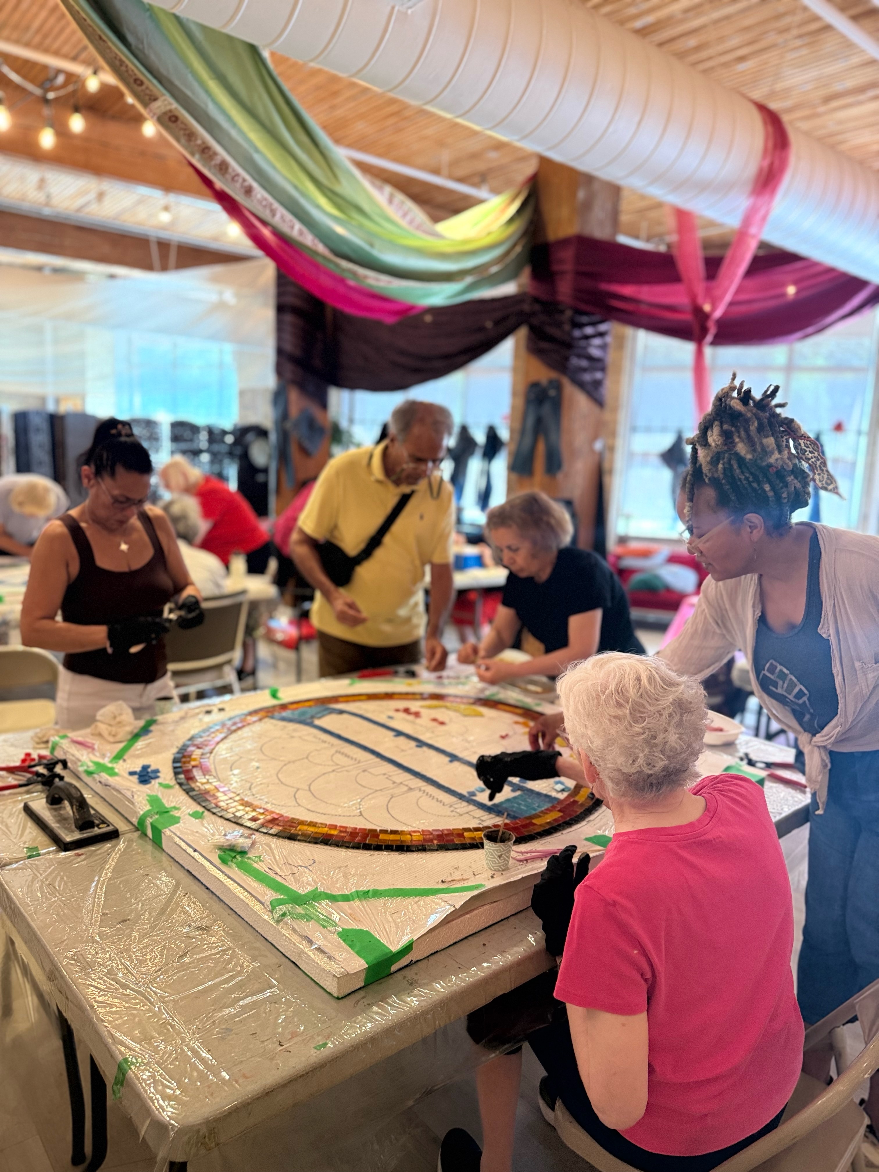 A story that started around a table is about to become part of The Esplanade!
This summer, Kevin Jiang @crudelykevin from the Toronto Star @thetorontostar joined one of our Belonging Older Adults mosaic workshops and spoke with familiar Jamii faces Brenda @bwoott and Mamie @hd_armaly about art, aging, friendship and finding a sense of belonging in the neighbourhood.
They also captured a project still taking shape: a permanent mosaic installation created by our community with artist Alex Ganassini of @dolomitemosaics for three stone tables on The Esplanade.
A special thank you to Rama Gaming House (Kennedy) @rama.gaminghouse and Charitable Gaming @cgamingcgood , whose funding covered Alex’s artist fee for this project. Their support gave our Belonging participants the opportunity to learn directly from Alex, develop their own ideas, and create a permanent artwork together for the neighbourhood.
We wrote more about the people behind the project, what these afternoons have meant to us, and where the mosaic is headed next.
Read the full Jamii Story and the Toronto Star feature through the link in bio.